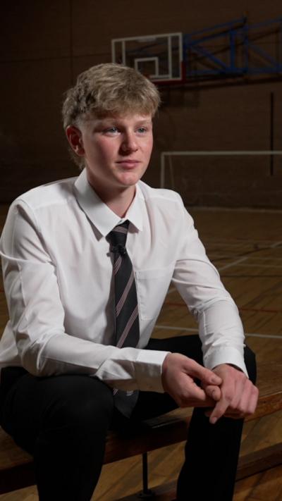 Loui – pupil wearing school uniform including tie and white shirt