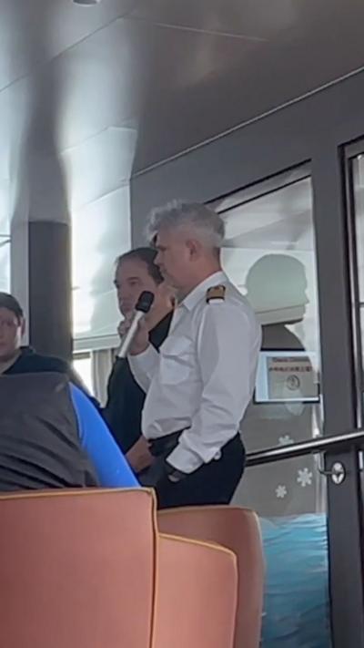 Ship captain speaking into a microphone 