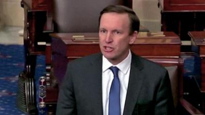 Senator Chris Murphy standing at podium