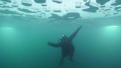 A person ice diving