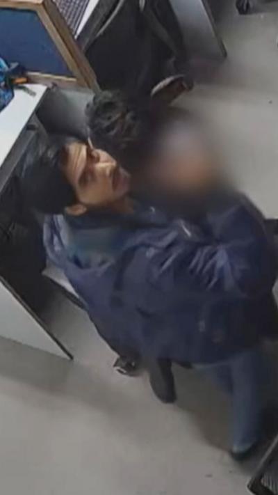 Man in call centre looks up a CCTV camera