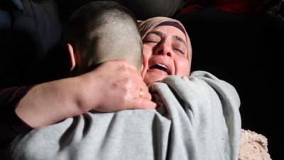 Woman looking emotional as she embraces man in a hug