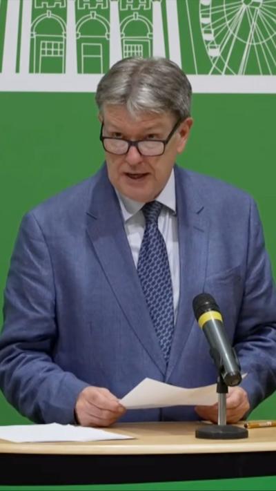 A man in a suit at a podium