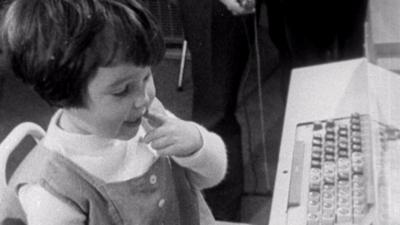 A child sitting at a keyboard.