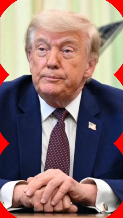 Donald Trump sat at a table with his hands clasped