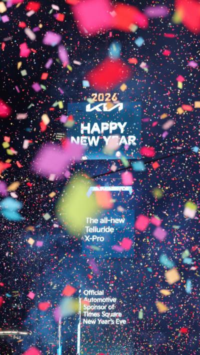 A screen displays "Happy New Year" message after the ball drop in Times Square