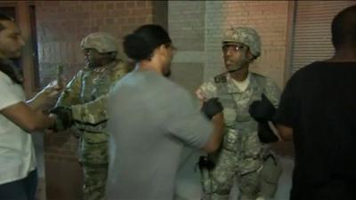 People shake hands with the National Guard in Charlotte, North Carolina