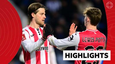 Mathias Jensen high fives Keane Lewis-Potter, both in Brentford kit