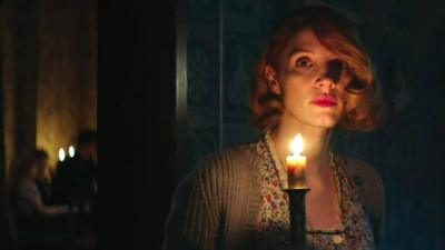 Actress Jessica Chastain holds a candle in a scene from The Zookeeper's Wife