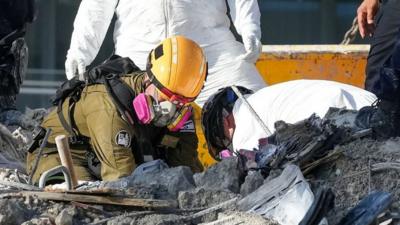 Workers in the rubble on 2 July 2021