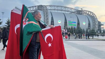 Man selling Turkey flags outside stadium