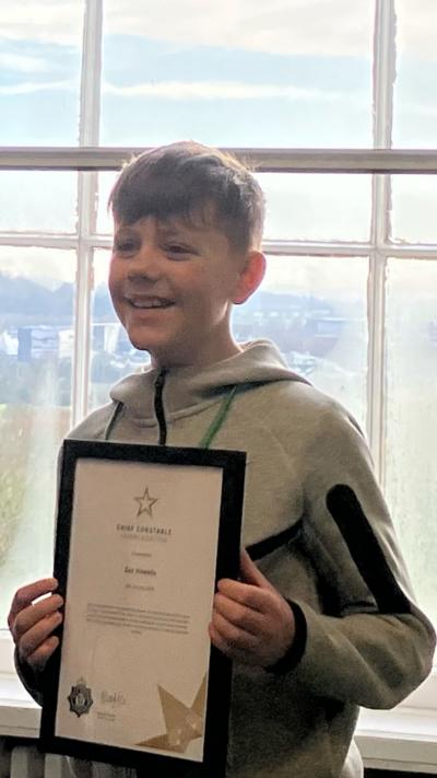 A boy holding a certificate