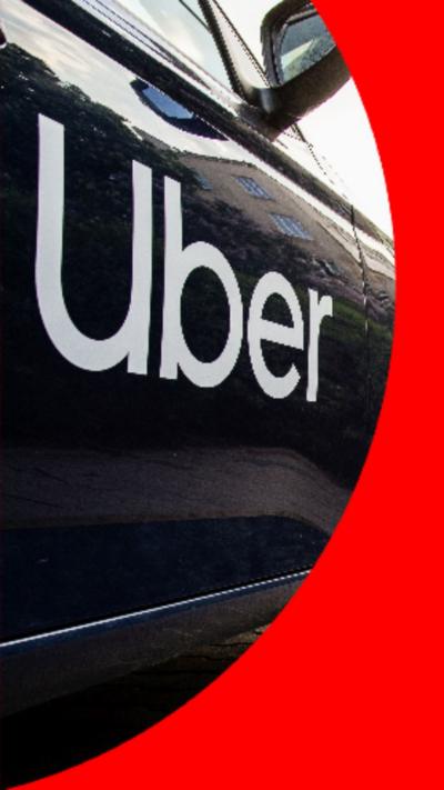 The side of a black car with the white uber logo.