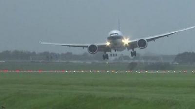 A plane struggles to land at Amsterdam's Schiphol airport.