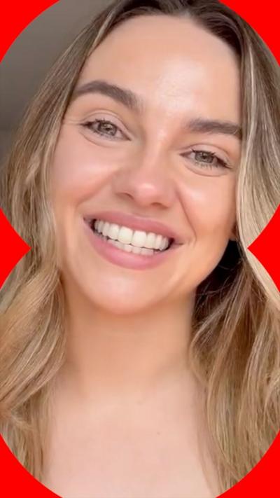 A blonde woman smiles.