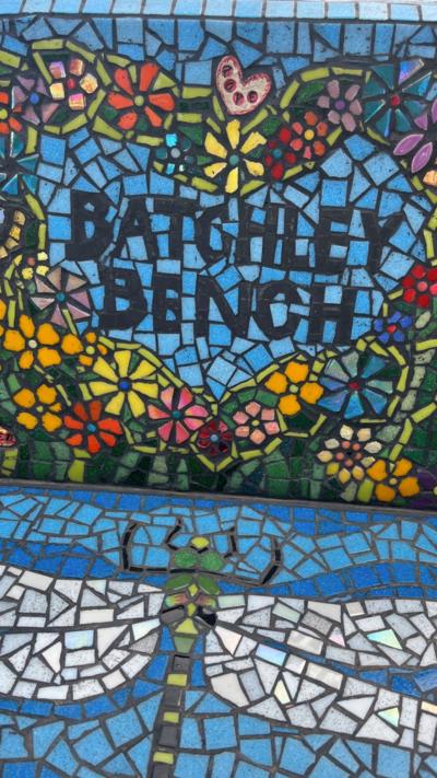 A blue bench made from tiles with Batchley Bench written on it