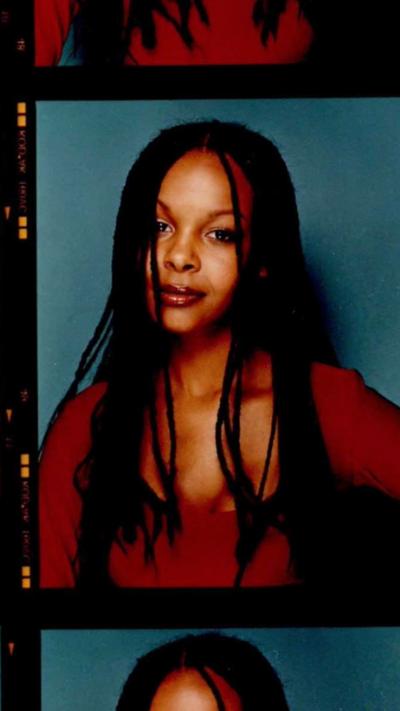 Colour film photographs of a young woman with long braided brown hair and a red top, against a blue backdrop
