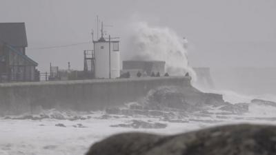 A huge wave hits a sea wall in Wales