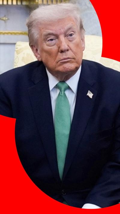 US President Donald Trump wearing green tie and navy suit