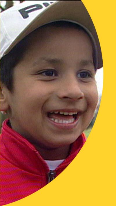5-year-old Aaron Kai wearing a white cap and a blue jumper.