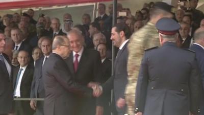 Lebanese President Michel Aoun (left) greets returning Prime Minister Saad Hariri (right)