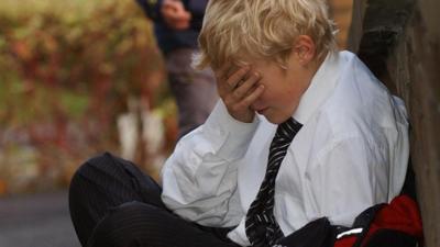 Posed photograph simulating a child being bullied bullying