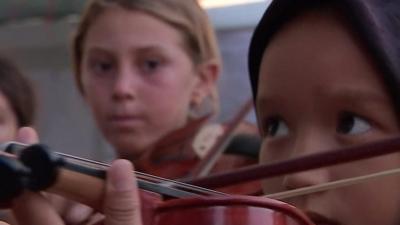 Refugee girl plays violin