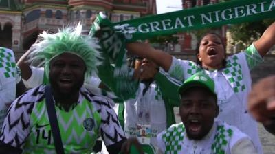 Excited Nigerian fans cheer in Moscow, Russia, dressed in their national kit