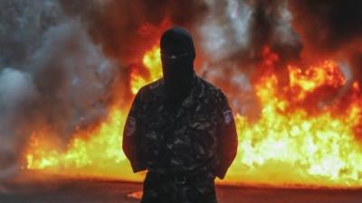 Protester in front of burning tyres, Kiev