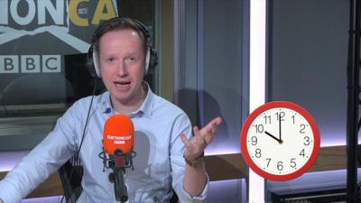 Adam Fleming with clock