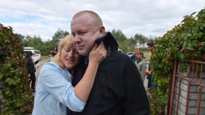 Ukrainian solders are reunited with their families in the largest exchange of prisoners with pro-Russia rebels since the conflict started in April 2014.