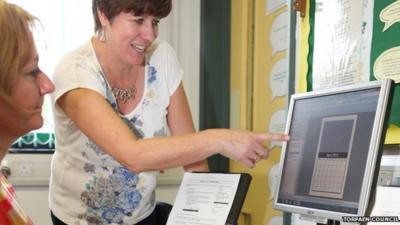 Woman teaching computer skills