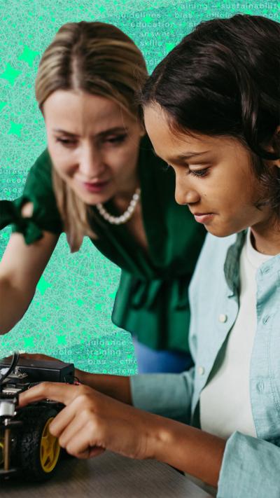 Teacher helps a student with a robotic device
