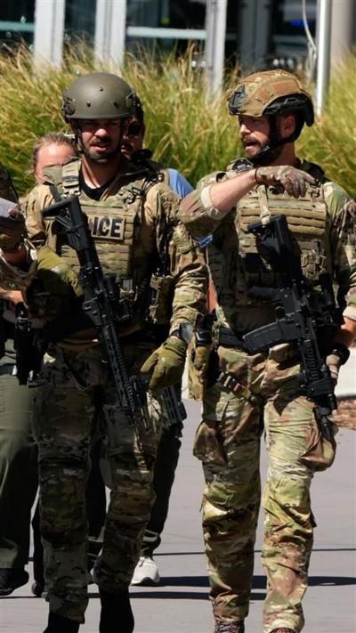 Two police officers wearing fatigue uniforms