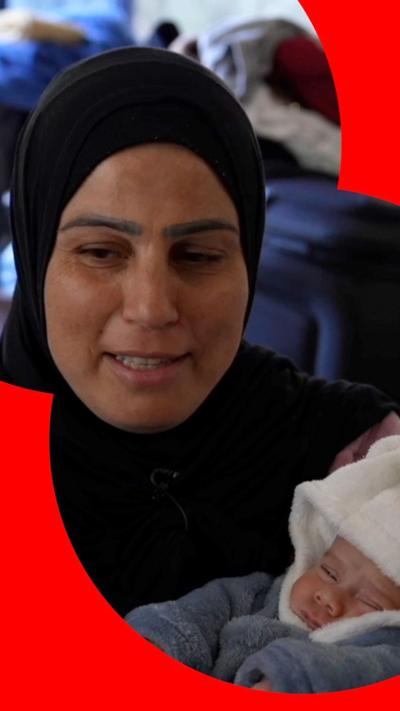 Ghada, holding her baby