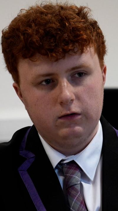 16-year-old boy with short red hair wearing tie and shirt