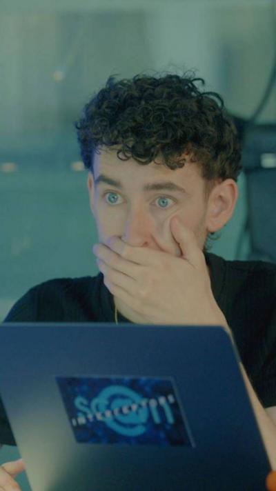 Scam Interceptors team member with his hand over his mouth in front of a laptop