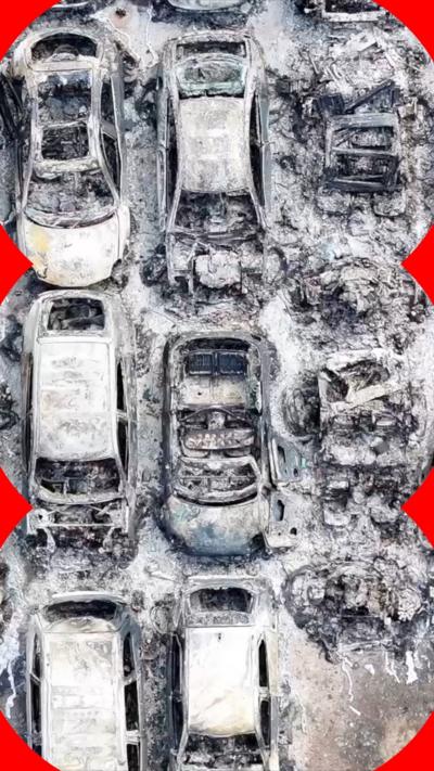 An aerial shot of burnt-out and melted cars at a car park.