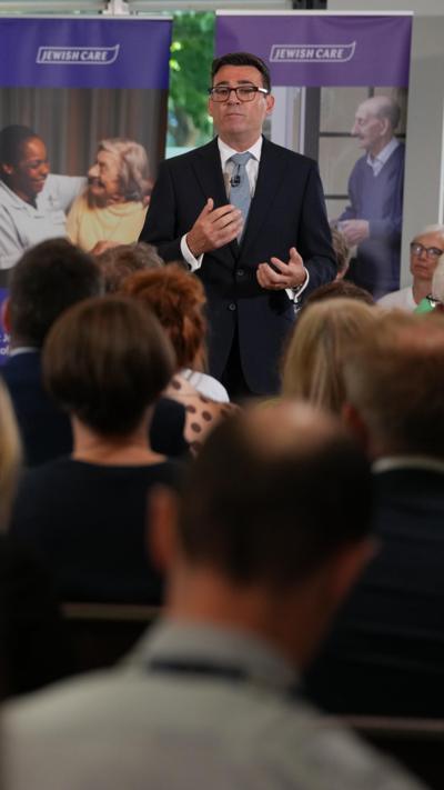 Any Burnham speaks to a crowd with people in the foreground