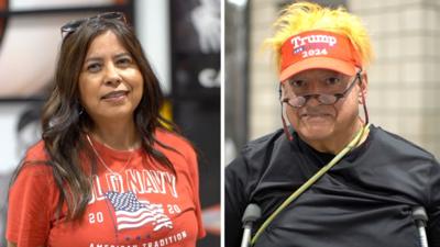 Two Americans being interviewed about Charlie Kirk - one wears a red T-shirt with the US flag, the other wears a Trump 2024 hat with blond wig