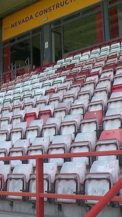 Football stands. Red and white chairs in rows. 