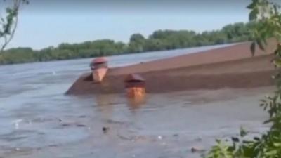 The roof of a building is seen floating above the water level of a flooded Dnipro River