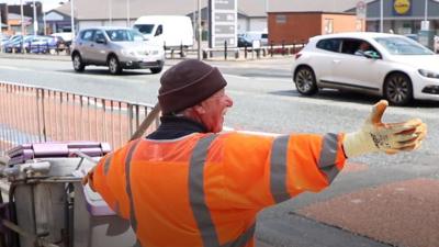 Street cleaner waving