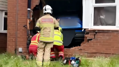 Firefighters at the broken wall