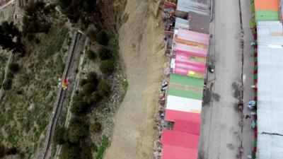 Shacks on edge of cliff face 