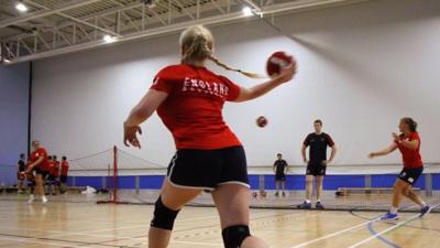 An England Lions player throws the ball