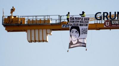 The father of a Parkland, Florida, high school shooting victim climbed a 150ft (47m) crane in front of the White House on the fourth anniversary of the mass shooting.