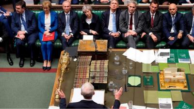 Jeremy Corbyn talks while Theresa May looks on