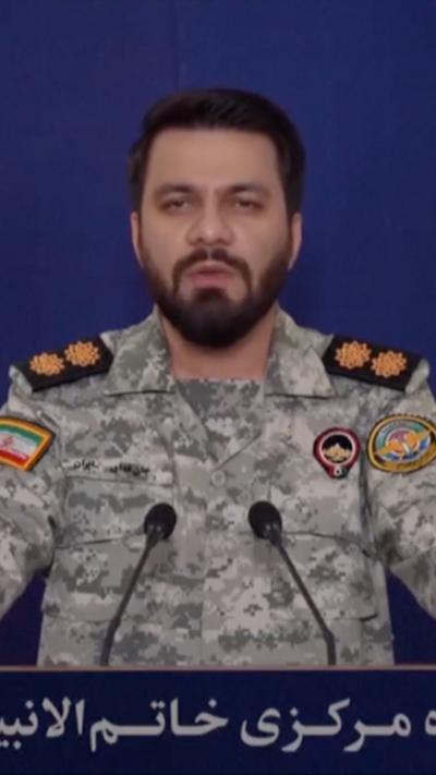 Still of Iranian commander delivering address