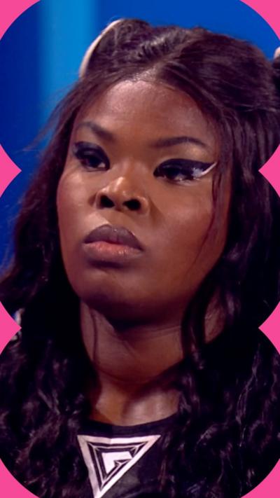 A close-up image of woman with black hair wearing a Gladiators top. She is looking offscreen and has black eye make-up on.